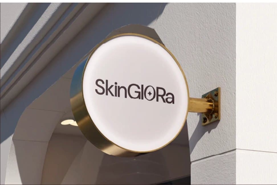Illuminated round shop sign with a brass bracket
